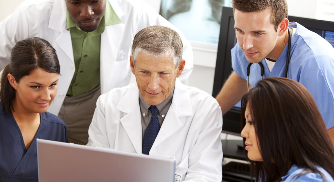 Physicians and staff around a computer