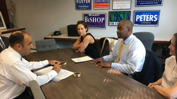 Three STS members meet with elected representative at a conference table